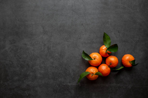 istock Fresh oranges seen from above on dark background. 1257863493