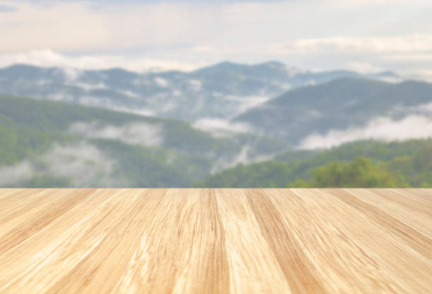 istock beautiful empty wood table with blur nature mountain with cloud background. Ready for product display  montage 1257868998