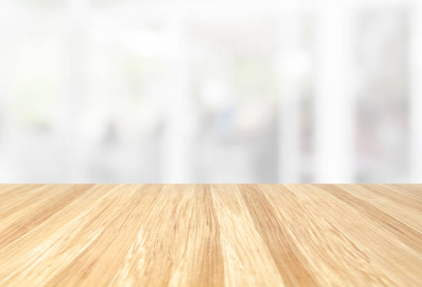 beautiful empty wood table with blur modern white kitchen and coffee cafe with window background, interior clean tone . Ready for product display  montage