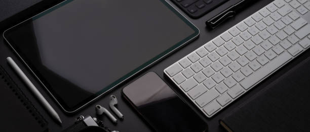 istock Digital devices with tablet, smartphone, keyboard and accessories on workspace 1257879572