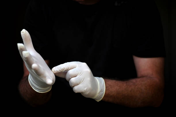 istock Person putting on a disposable gloves 1257880672