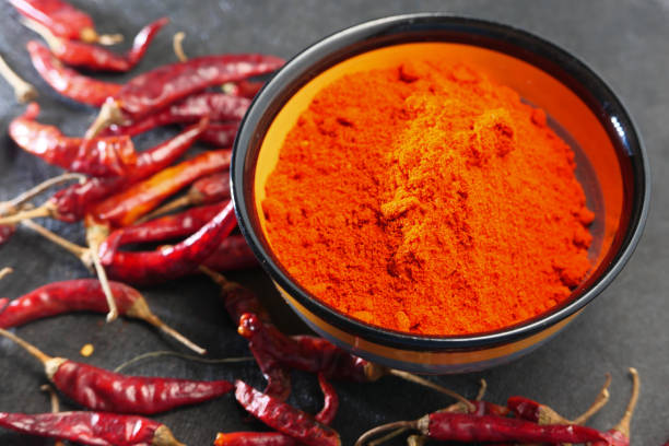 istock Chili powder and dried peppers on table background. 1257881351