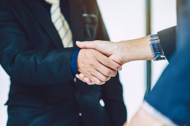 istock Two businessman shaking hands greeting each other. 1257882726