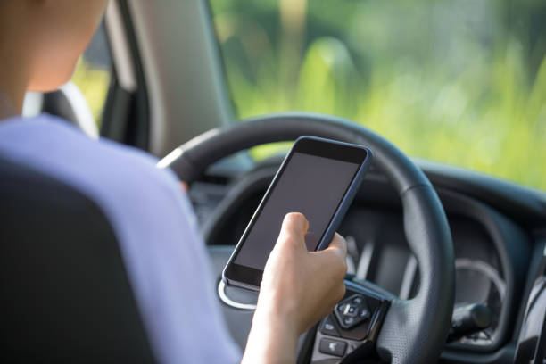 istock Woman driver using smartphone while driving a off road car in the nature 1257886199