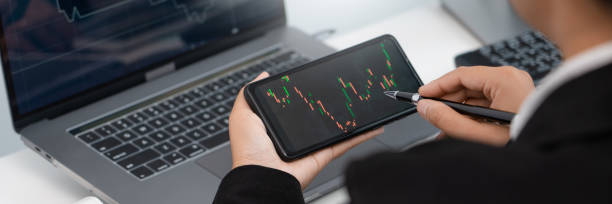 istock Stock market analysis successful broker or traders looking and focused talking about forex charts and data on multiple computer screens of stock market 1257886310