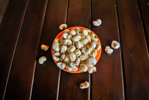 istock Popcorn in an orange bowl on wooden table 1257889199