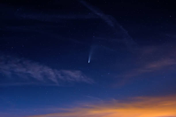istock Neowise comet on dark cloudy starry sky at dusk 1257889995