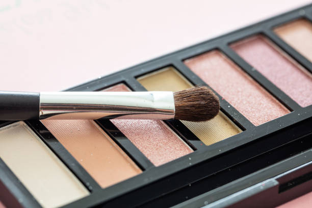 istock Eye shadow pallete kit against pink background, copy space 1257891595