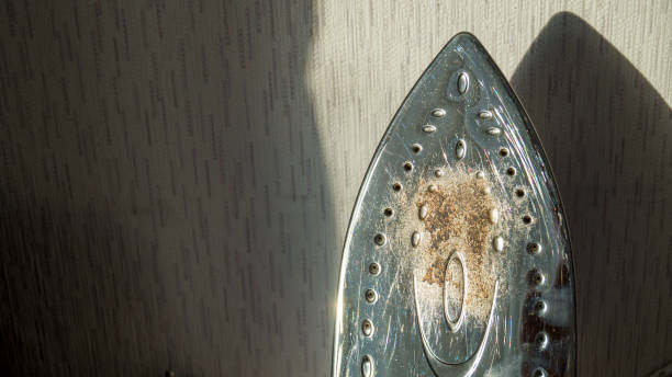 Simple badly burnt damaged metal iron bottom, scorched iron, ironing issues. Simple badly burnt damaged metal iron bottom, scorched iron, ironing issues, dirty destroyed iron surface texture macro, closeup. Damage, household appliances goods cleaning. scuff marks photos stock pictures, royalty-free photos & images