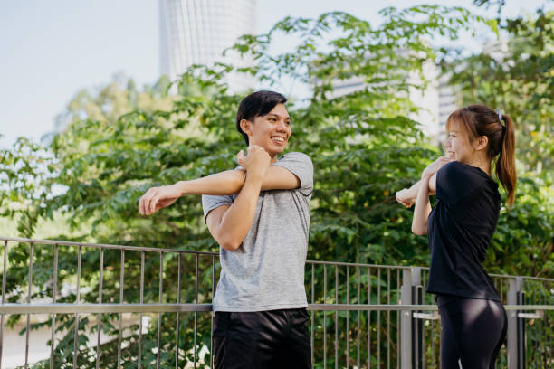istock Young asian couple stretching and get ready for work out 1257898932