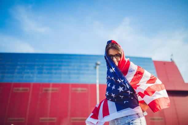 istock Girl wrapped in USA flag 1257905076