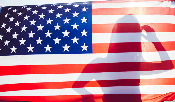 istock Female silhouette behind USA flag 1257905154