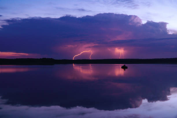 istock several lightning strikes during a strong thunderstorm over the lake 1257909006