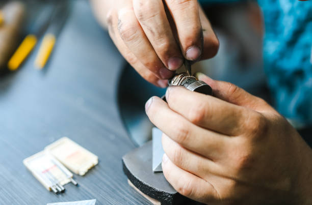 istock Master goldsmith while working on jewelry on the of work table. 1257910147