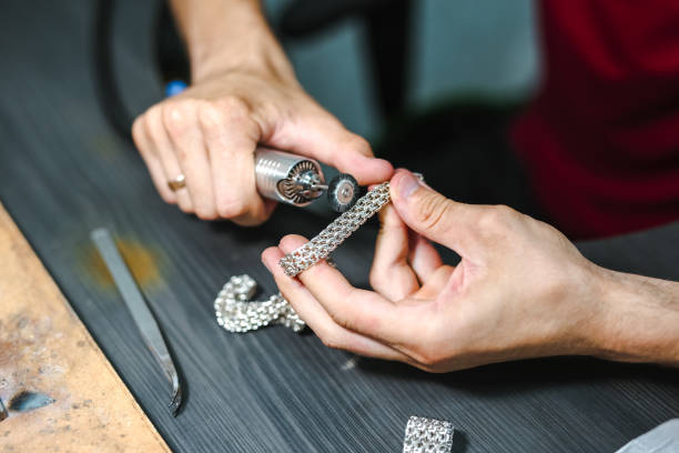 istock Master goldsmith while working on jewelry on the of work table. 1257910156