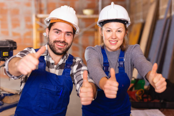 istock Portrait of two successful workers in uniform inside brick cottage 1257912592