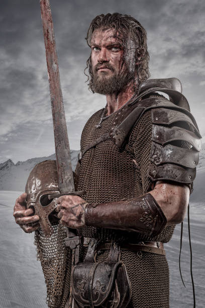 istock Weapon wielding bloody young viking warrior in studio shot 1257912809