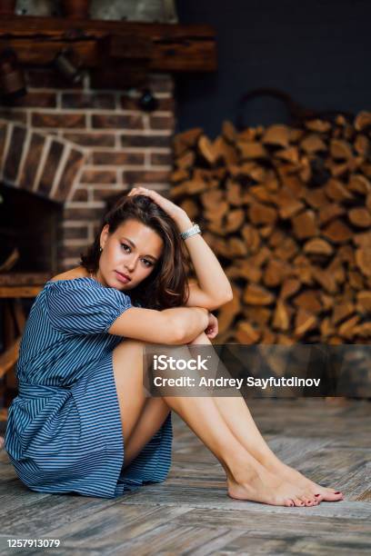 Beautiful Girl In Blue Dress Sit Barefoot On Floor Stock Photo ...