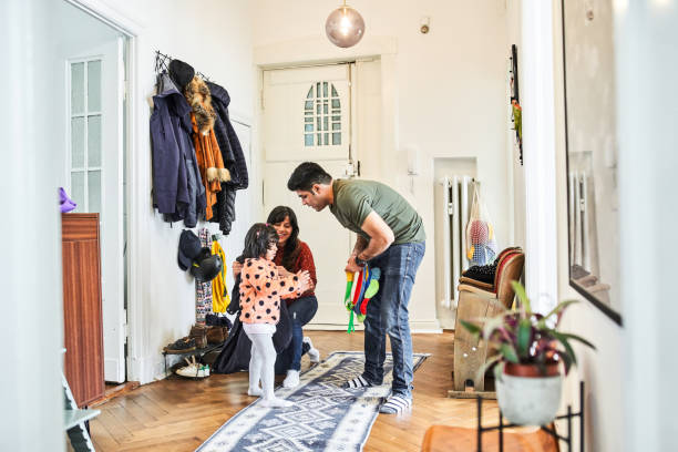 istock Mother wearing jacket to daughter 1257915432