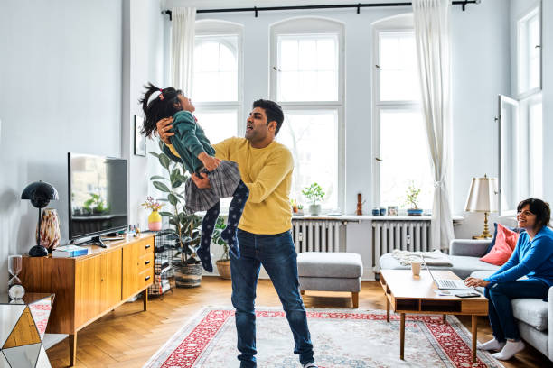 istock Man playing with daughter at home 1257915529
