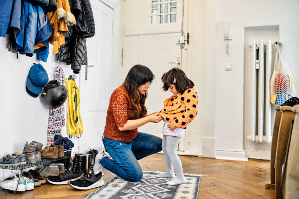 istock Woman wearing jacket to daughter 1257915619