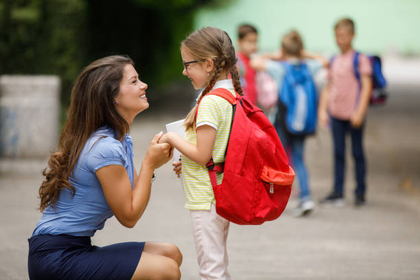 istock Mother sending her daughter to school 1257916923