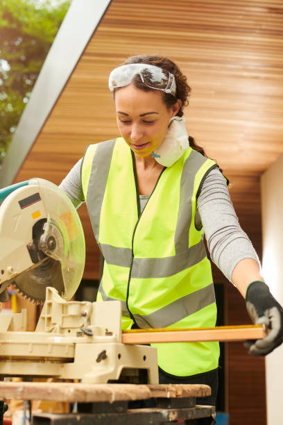 istock female carpenter with circular saw 1257918244