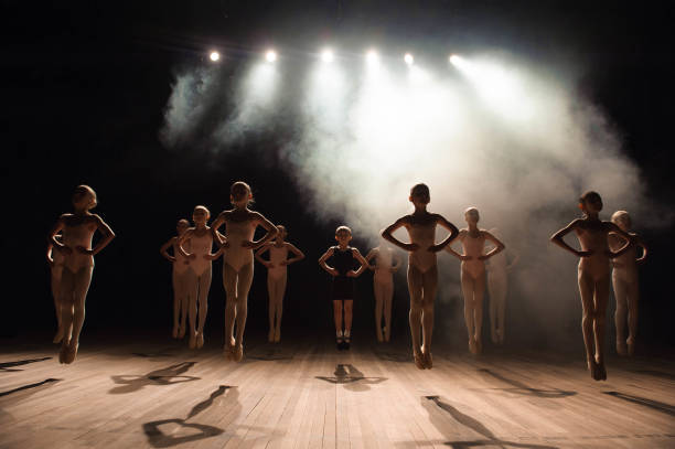 istock happy children doing ballet jump 1257918718