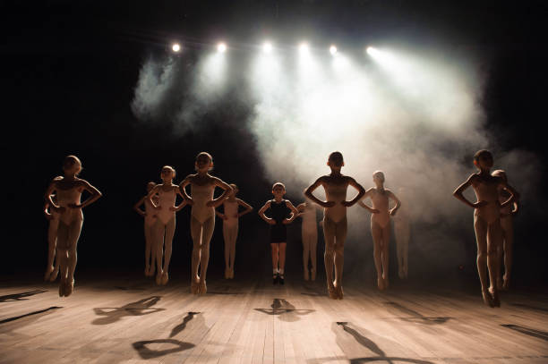 istock happy children doing ballet jump 1257918730