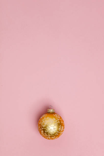 istock Gold Christmas ball on pink background. Flat lay 1257919938