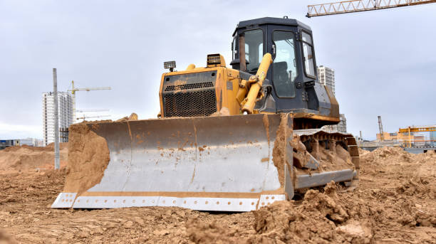 istock Dozer working at construction site. Bulldozer for land clearing, grading, pool excavation, utility trenching and foundation digging. Crawler tractor and earth-moving equipment 1257920906