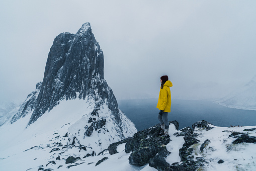 Woman standing near  Segla mountain  in Norway in winter