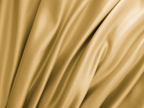 istock Beautiful smooth elegant wavy golden yellow satin silk. 1257921598