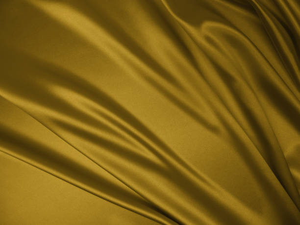 istock Beautiful smooth elegant wavy golden yellow satin silk. 1257922230