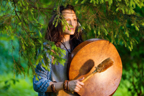 istock Female shaman performs a ritual with a tambourine 1257924621