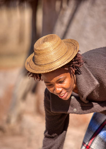 istock african woman wearing a hat in her yard 1257926809