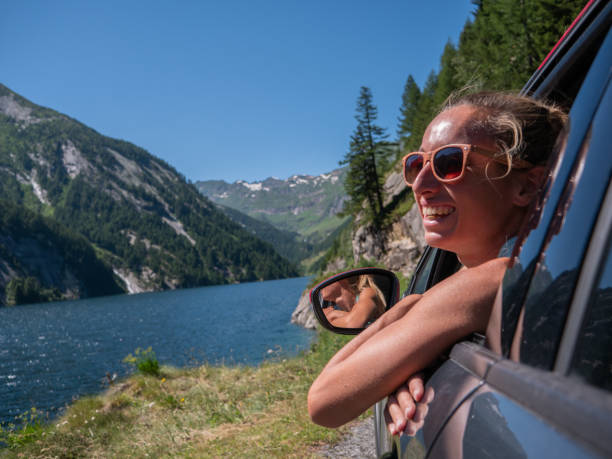 istock Woman in car looking at mountain panorama 1257928200