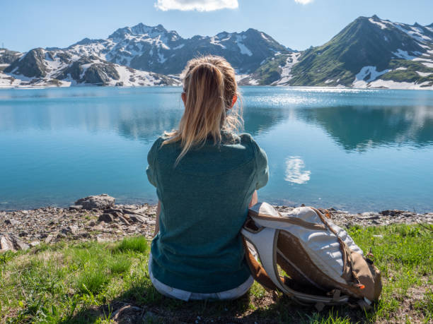 istock Young woman on mountain top contemplating view 1257929866