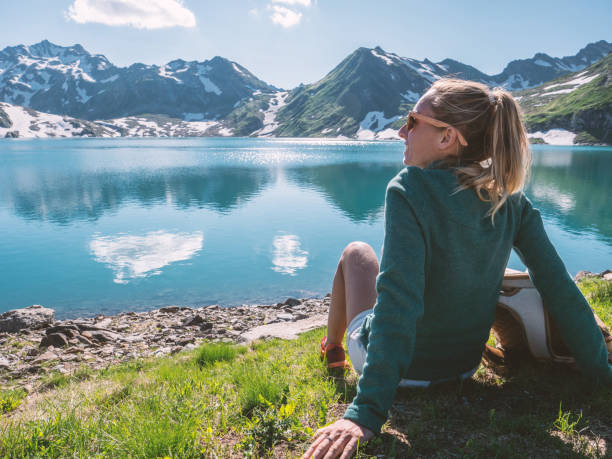 istock Young woman on mountain top contemplating view 1257932129