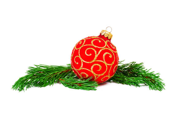 istock red Christmas ball with green pine tree branches on white background 1257932173