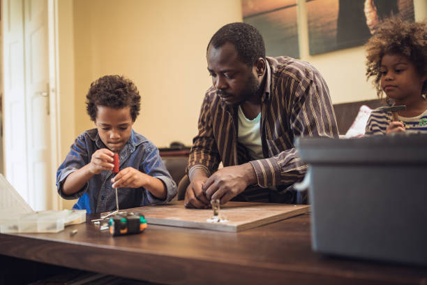 istock Helping father assembling furniture with kids 1257933588