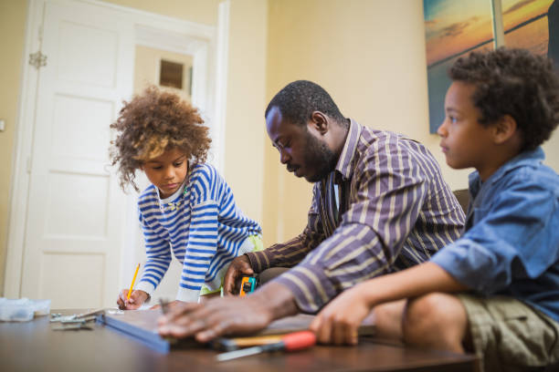 istock Helping father assembling furniture with kids 1257933644