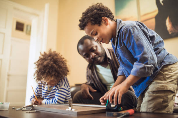 istock Helping father assembling furniture with kids 1257933658