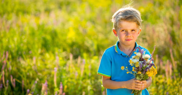 istock The little boy with flowers 1257933717