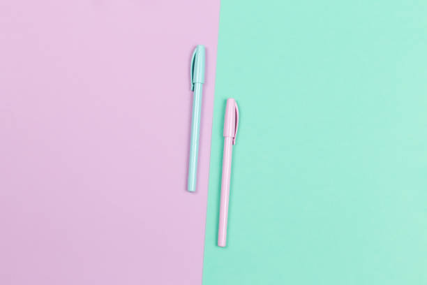 istock Two pens on a violet and turquoise background. 1257933838
