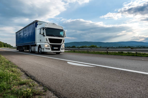 istock Big semi trailer truck on a highway at sunset 1257933855