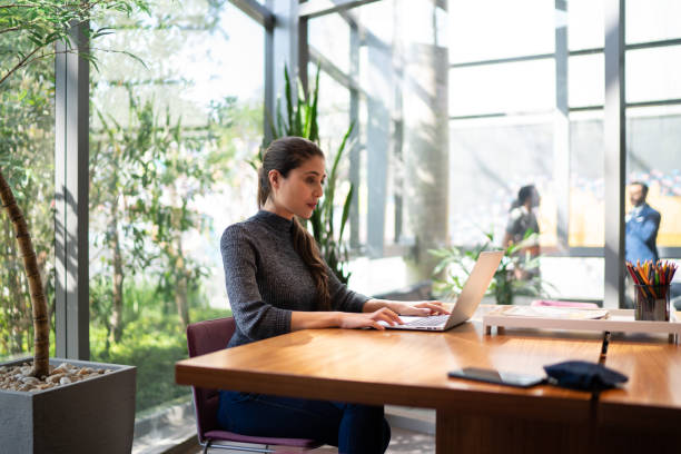 istock Businesswoman working in an office, using laptop 1257934902