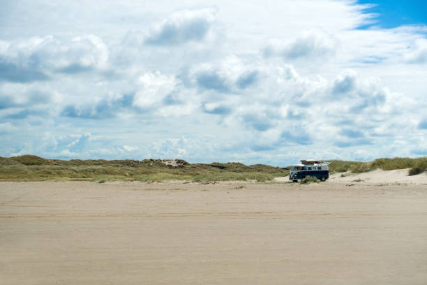 Texel, Netherlands - August 13, 2014:De slufter on the west frisian wadden Island Texel is a tidal creek and nature reserve.The wadden islandsof the Netherlands are the Unesco heritage list. There are some walking people in the landscape.