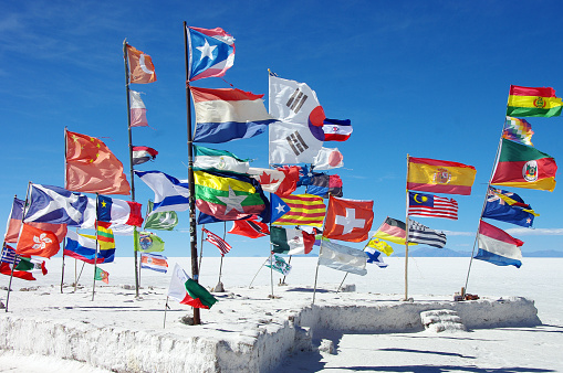 Flags of many nations in the salt flats of Salar de Uyuni in Bolivia