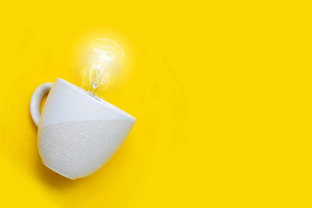 istock Light bulb in white cup on yellow background. Ideas and creative thinking concept. 1257936776